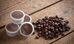 point espresso coffee capsules with-coffee-beans-at-the-table-